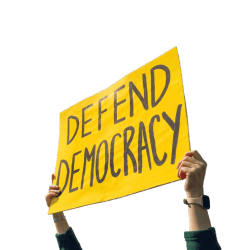Two arms extending from off screen holding a yellow sign reading 